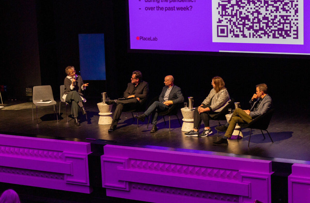 A panel discussion sits on the stage at the Capitol venue.