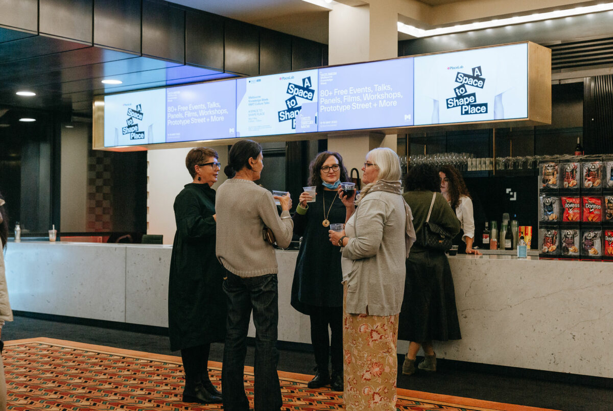 A group of people with drinks after the event.