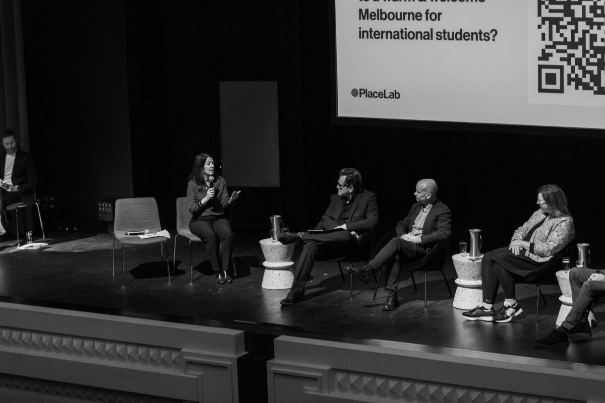 A panel discussion sits on the stage at the Capitol venue.