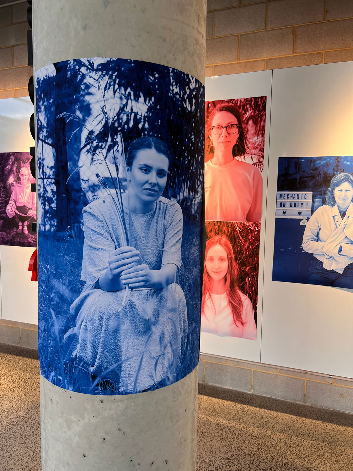 The portraits are installed in the PlaceLab studio, on the wall and column.