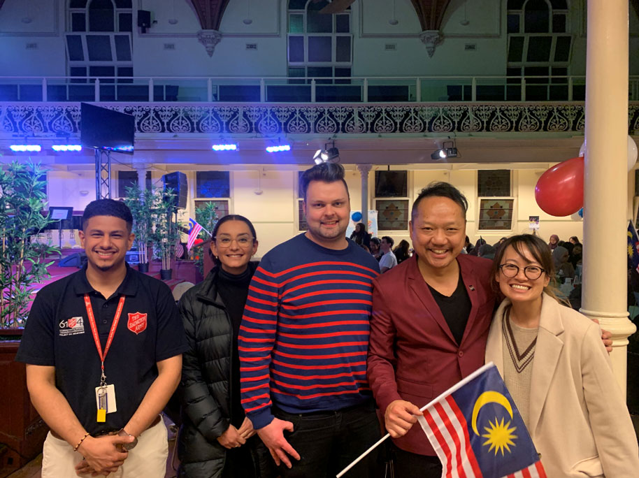 A group of 5 people smiling at the camera