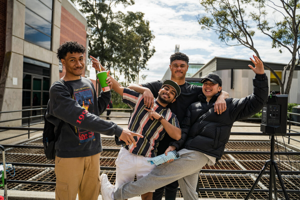 4 Students playing and smiling