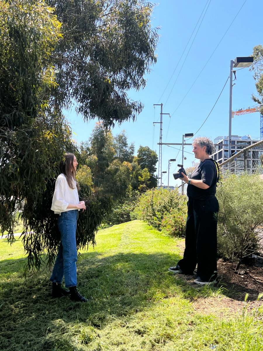 A woman prepares to take a photo of another woman.