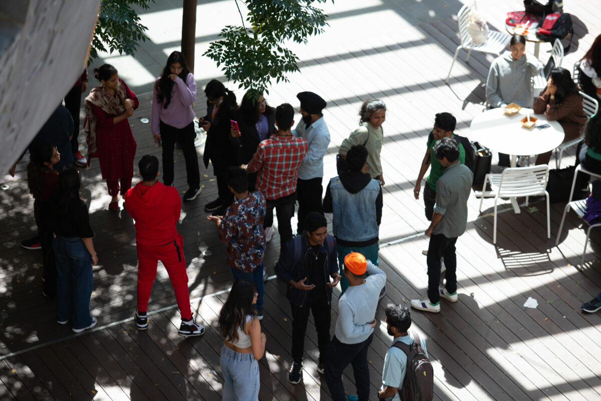 A crowd below mingles.