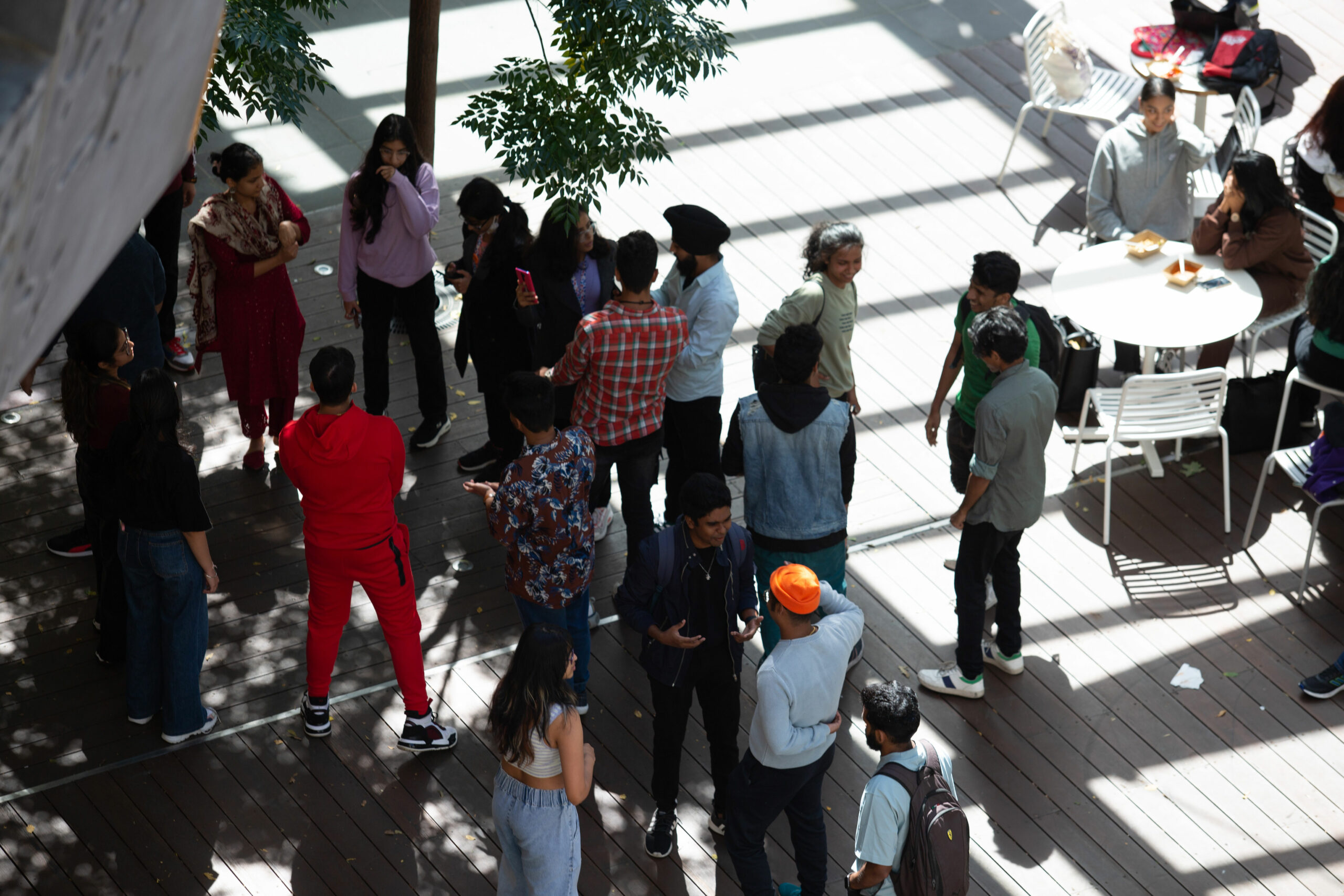 A crowd below mingles.