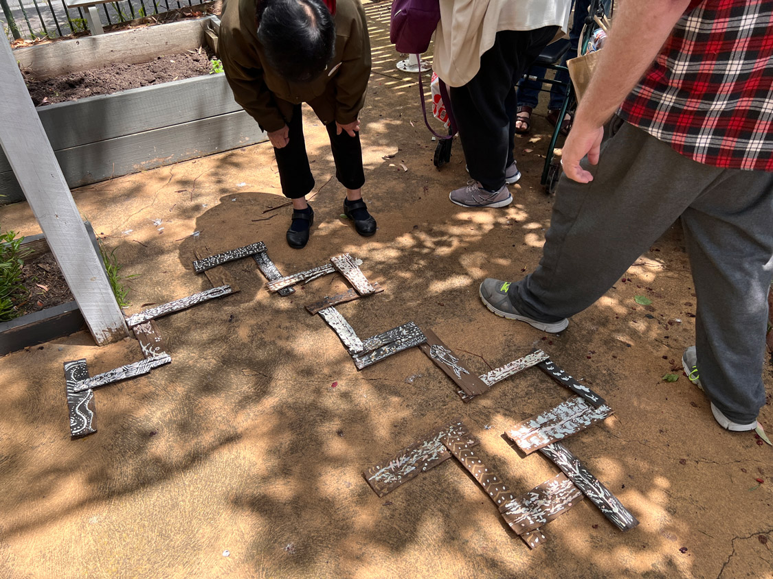 An artistic arrangement of painted bark under a tree.