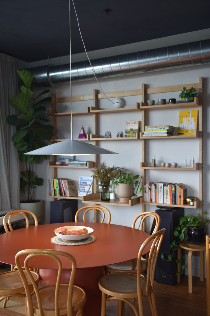 A close-up shot of a book shelf and kitchen table.