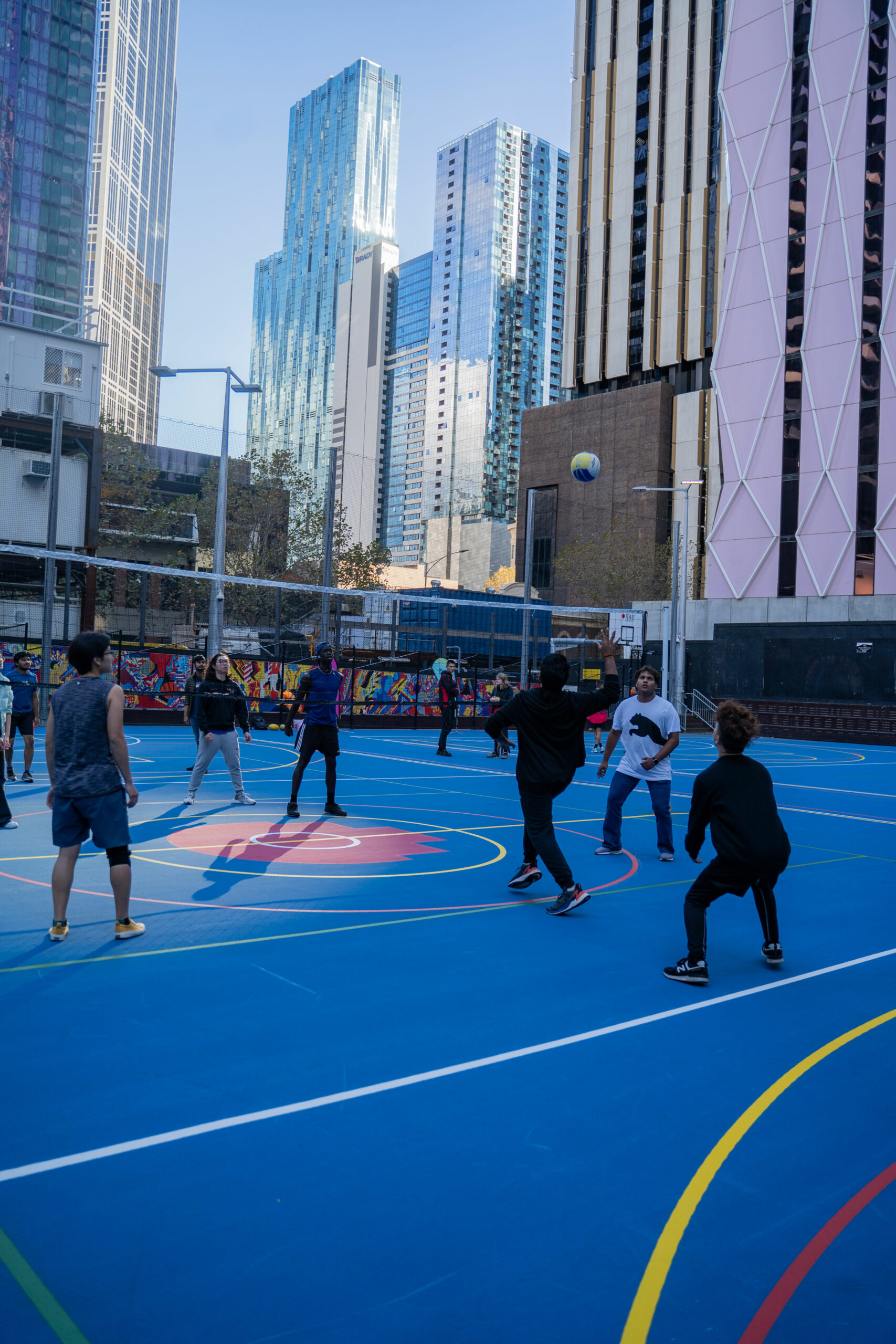 A group plays volleyball.