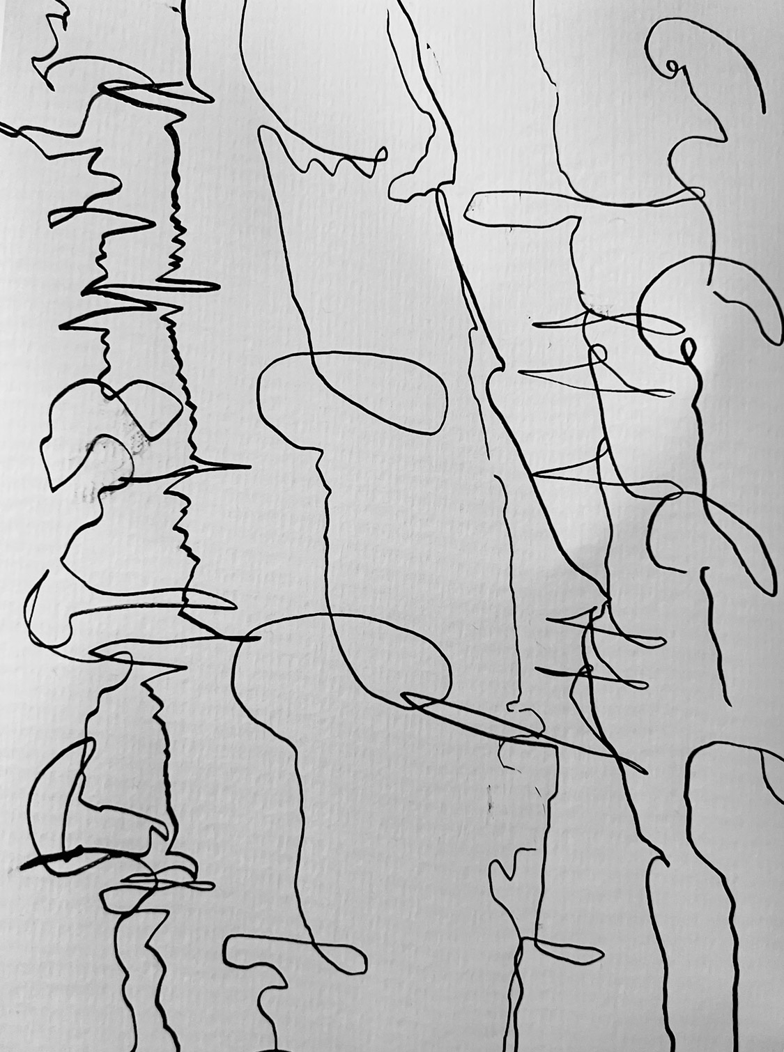 Scribbles in black on white paper.