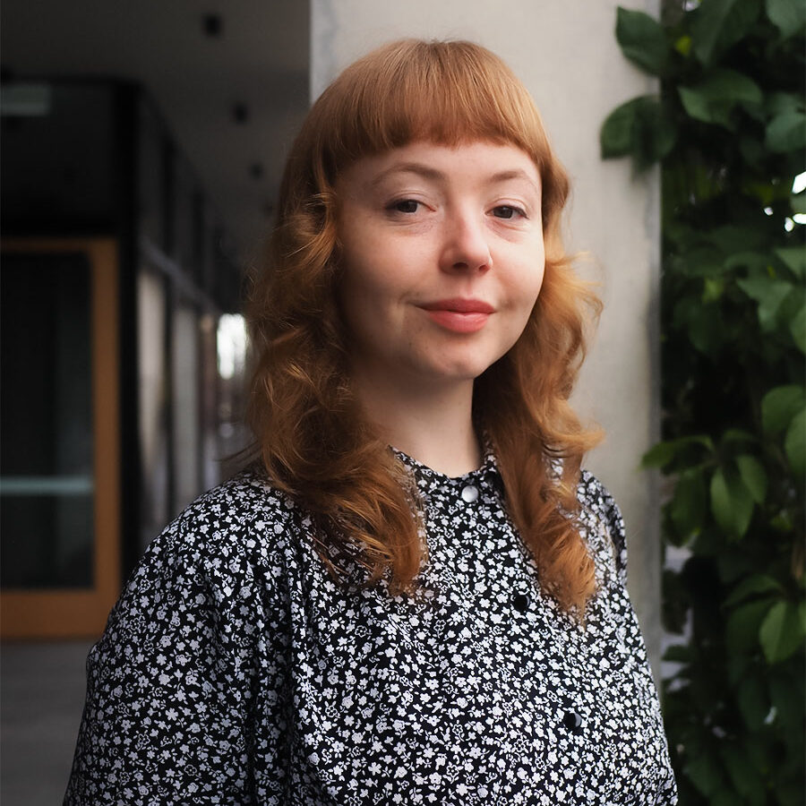 Woman smiling with curly hair.