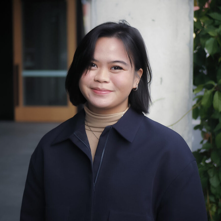 Woman smiling wearing jacket.