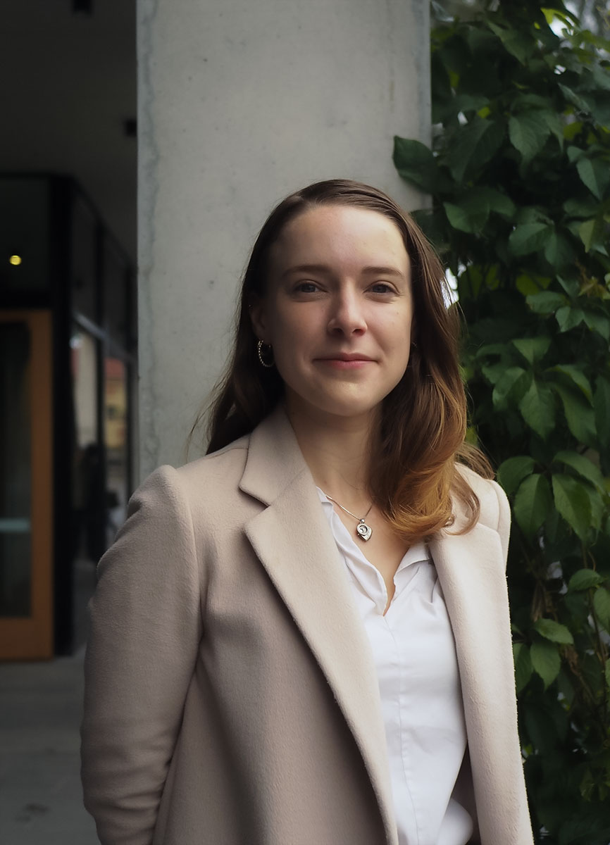 Woman smiling wearing necklace.
