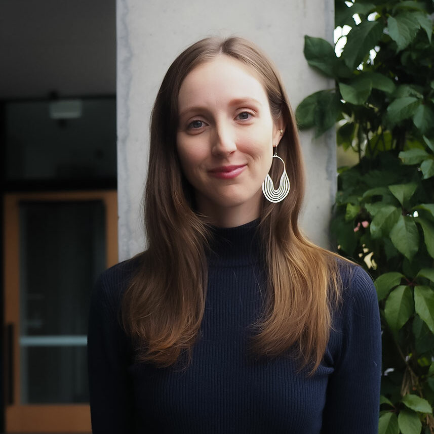 Woman smiling wearing earring.