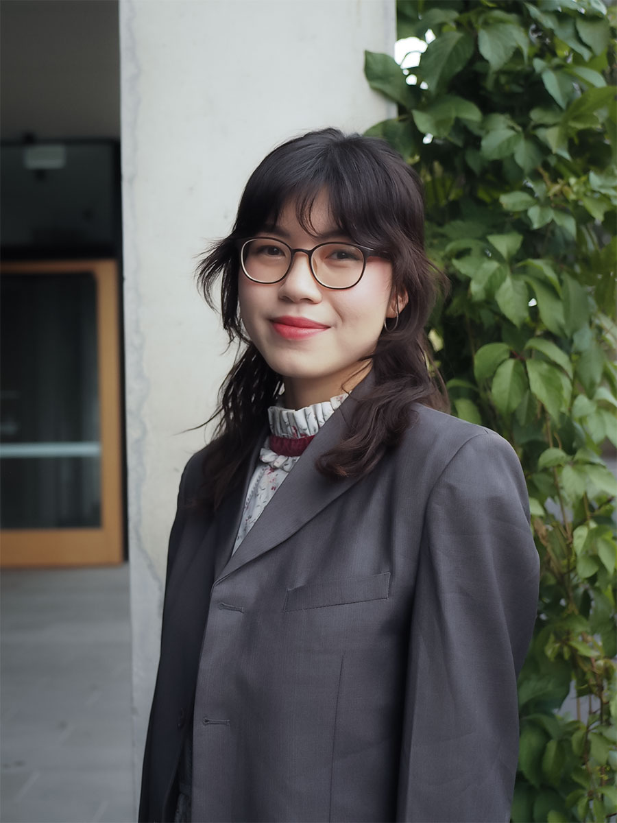 Woman smiling with glasses.